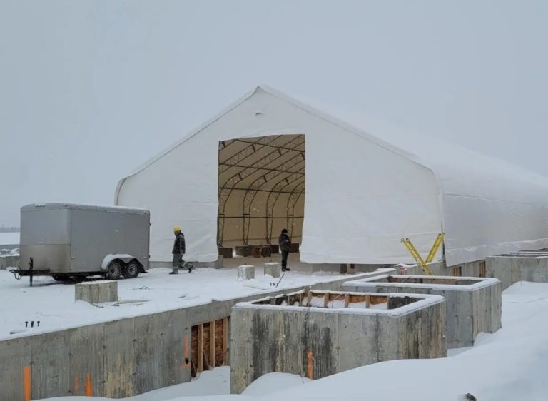 How a tensioned dual-truss storage shelter outperforms a bare steel frame on the open farm