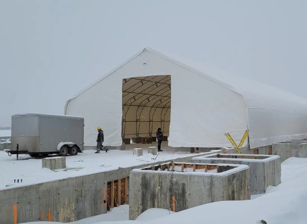 How a tensioned dual-truss storage shelter outperforms a bare steel frame on the open farm